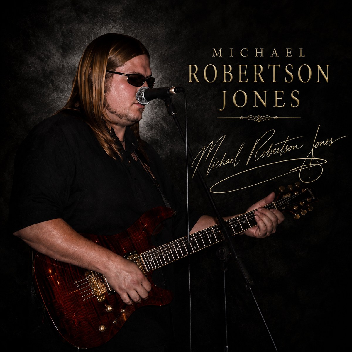 Michael Robertson Jones — Mikee — playing guitar, with his signature
